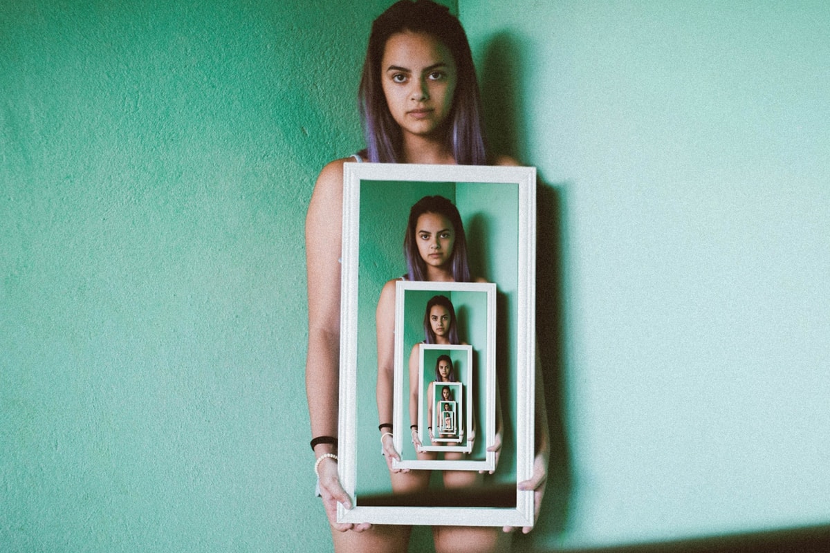 Girl holding a never-ending photo of herself.